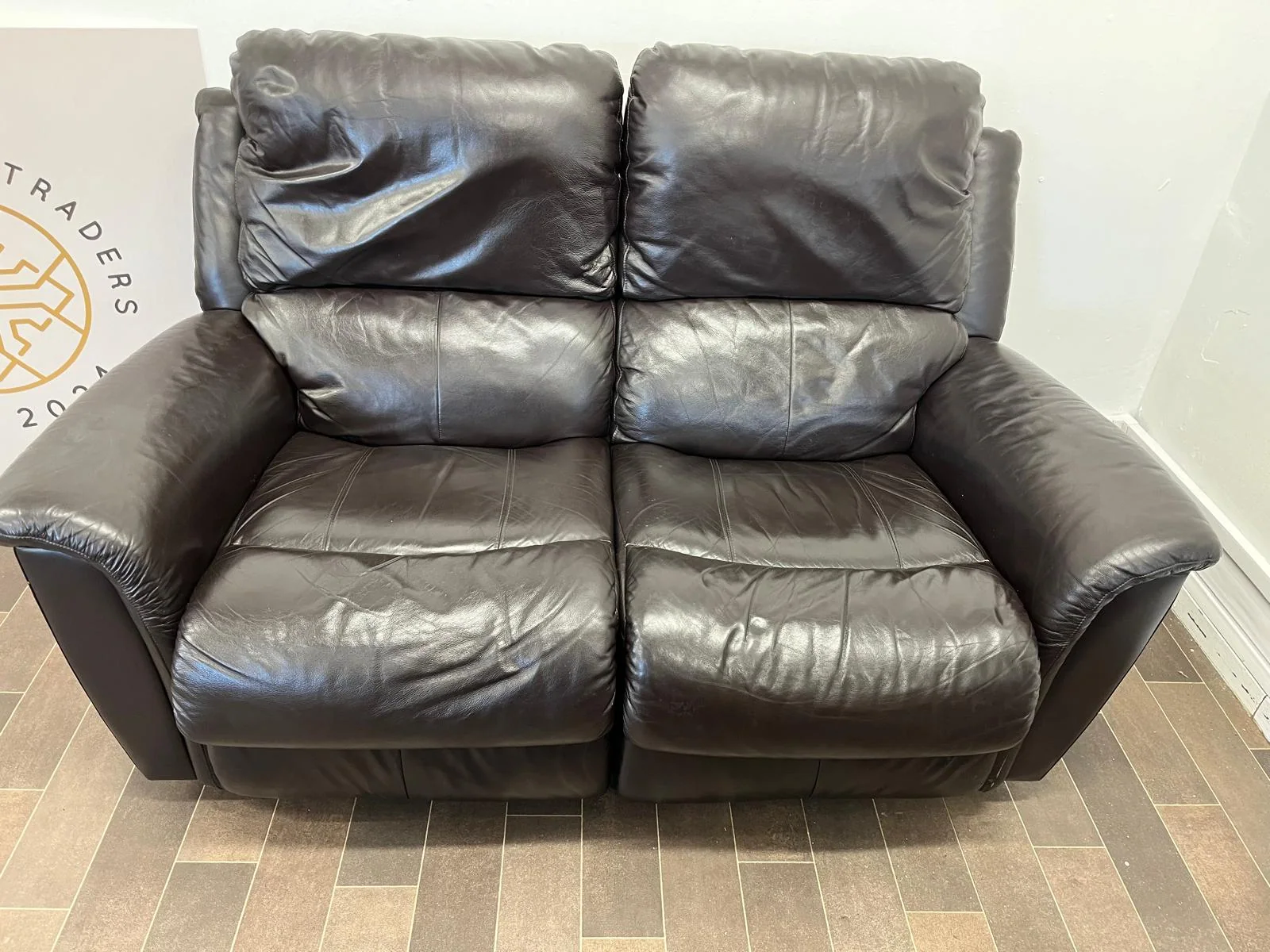 Dark leather two-seat reclining sofa
