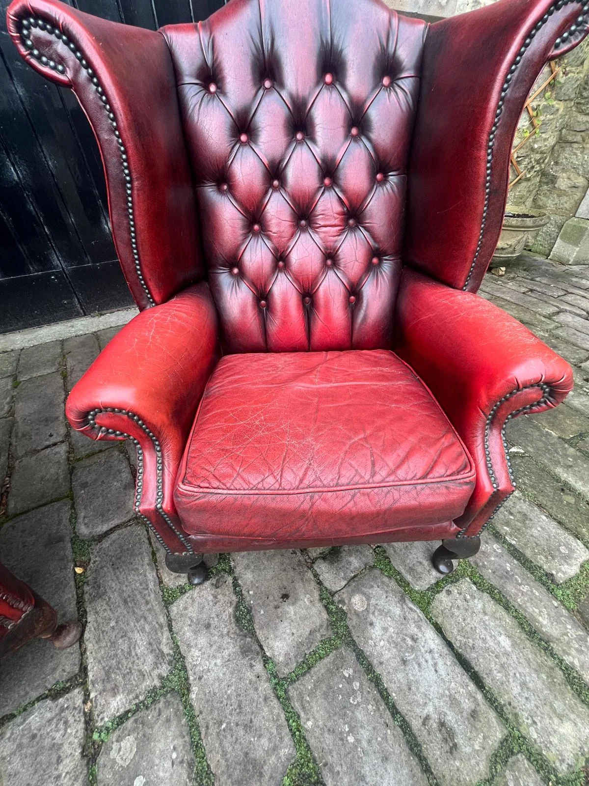 Red buttoned leather wingback chair